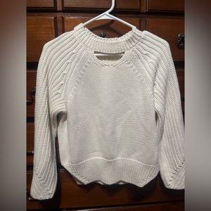 White knit sweater with circle cut out in the front
